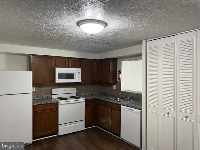 a kitchen with a refrigerator stove and microwave