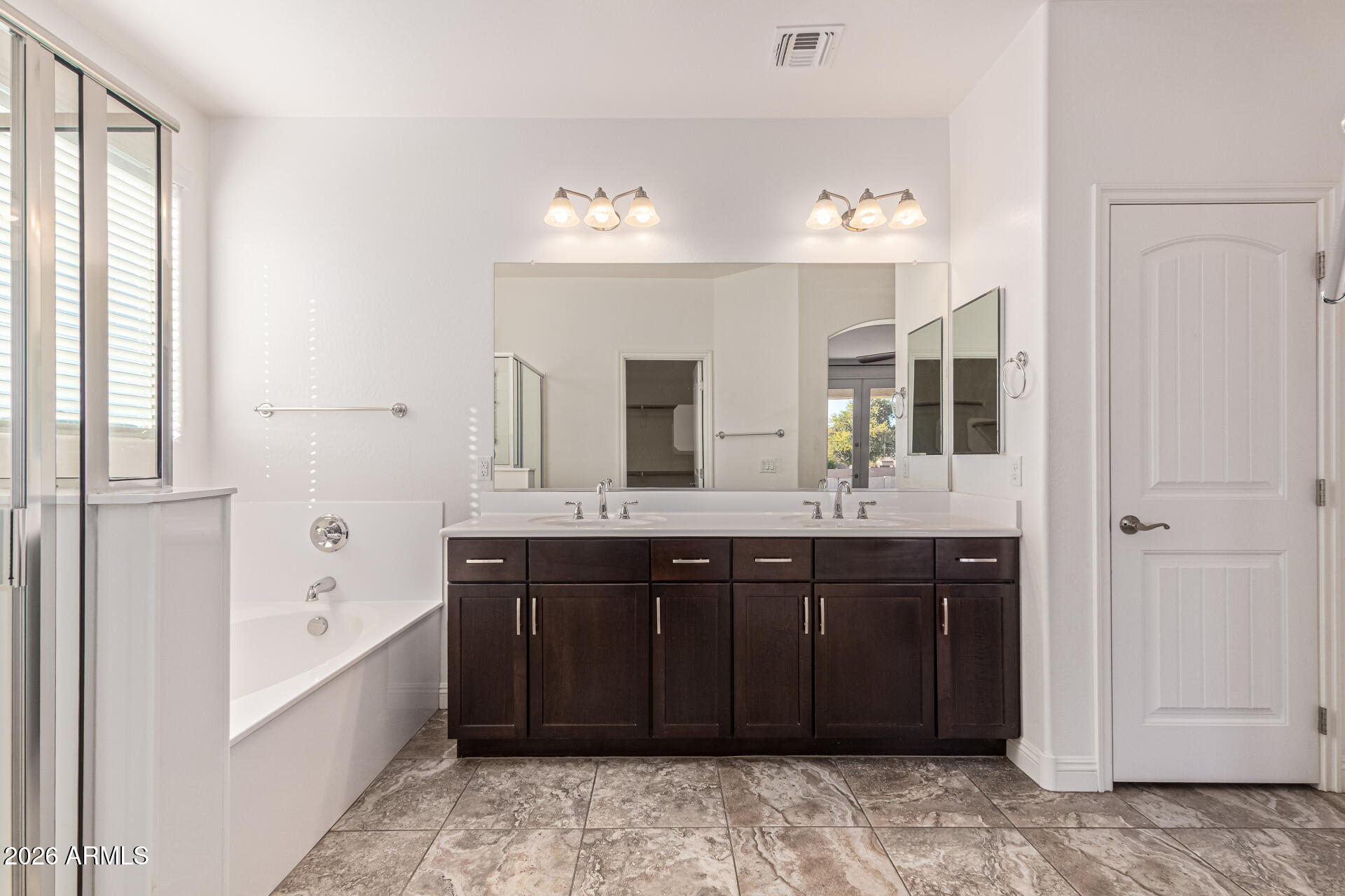 32187 North Royce Road San Tan Valley, AZ 85144 - Photo 15 of 38 a spacious bathroom with a bathtub sink and mirror