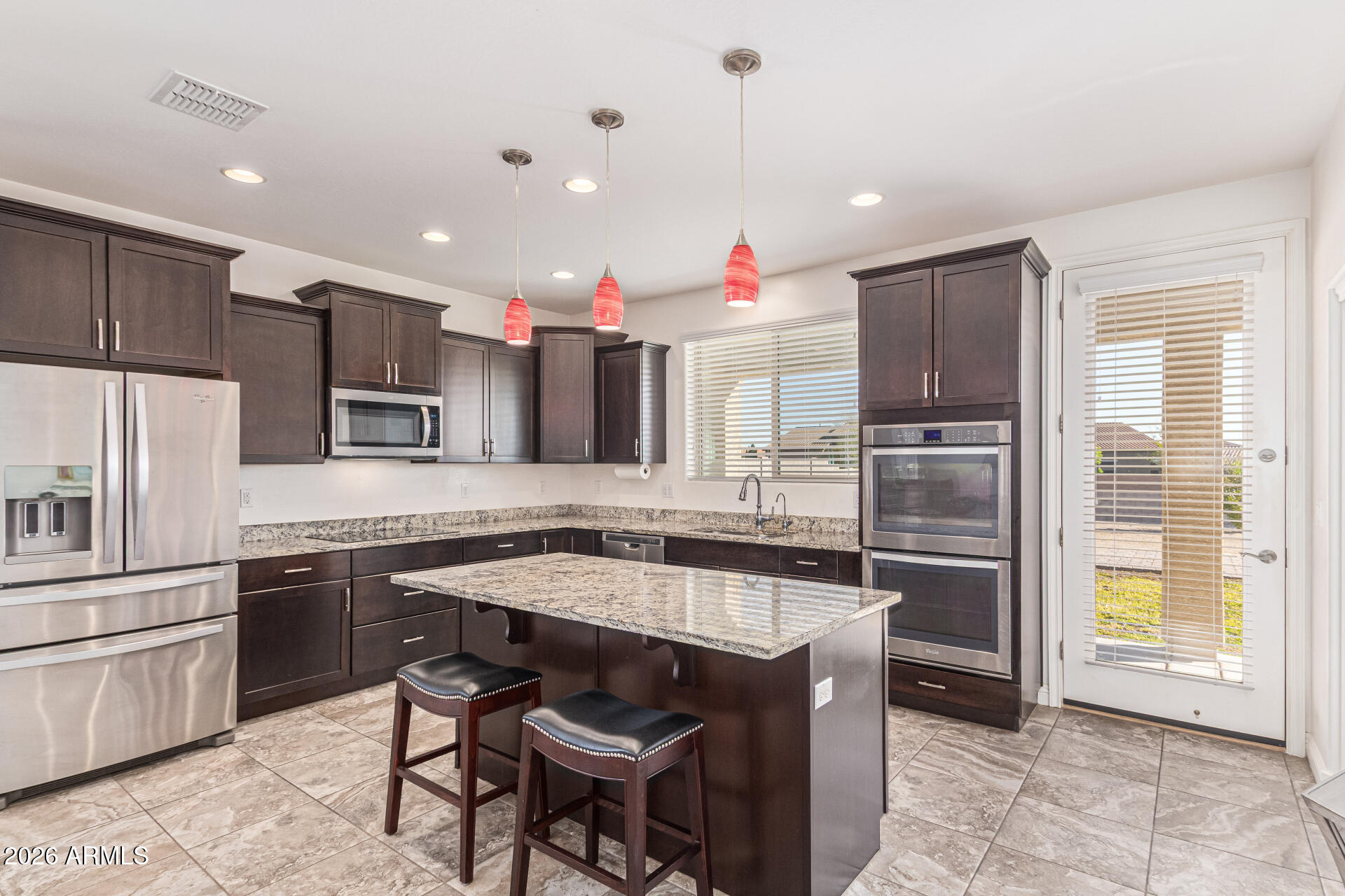 32187 North Royce Road San Tan Valley, AZ 85144 - Photo 10 of 38 a kitchen with kitchen island granite countertop a sink stove and refrigerator