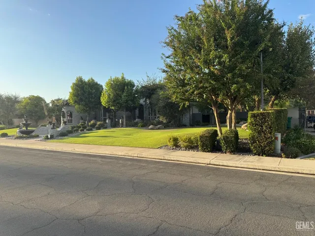 a view of a swimming pool with a yard