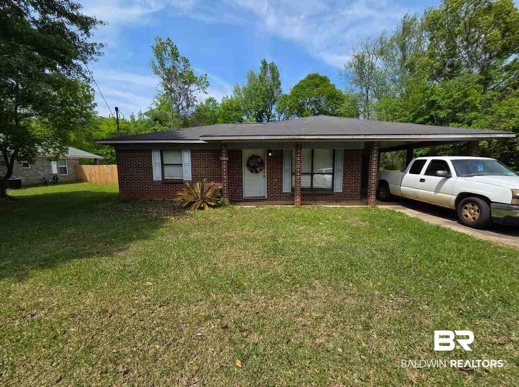 106 West 16th Street Bay Minette, AL 36507 - Photo 1 of 19 View of front of home featuring an attached carport, brick siding, and driveway