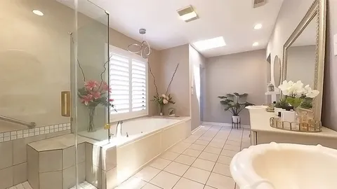a spacious bathroom with a bathtub and sink