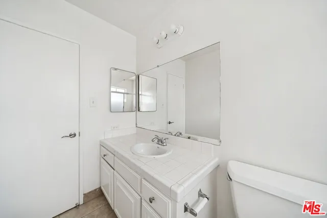 a bathroom with a sink toilet and mirror