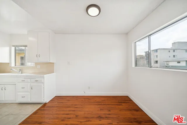 a view of a kitchen with sink dishwasher and wooden floor