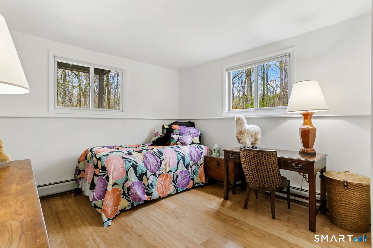 86 Seventy Acre Road Redding, CT 06896 - Photo 28 of 40 a bedroom with a bed table chair and a window