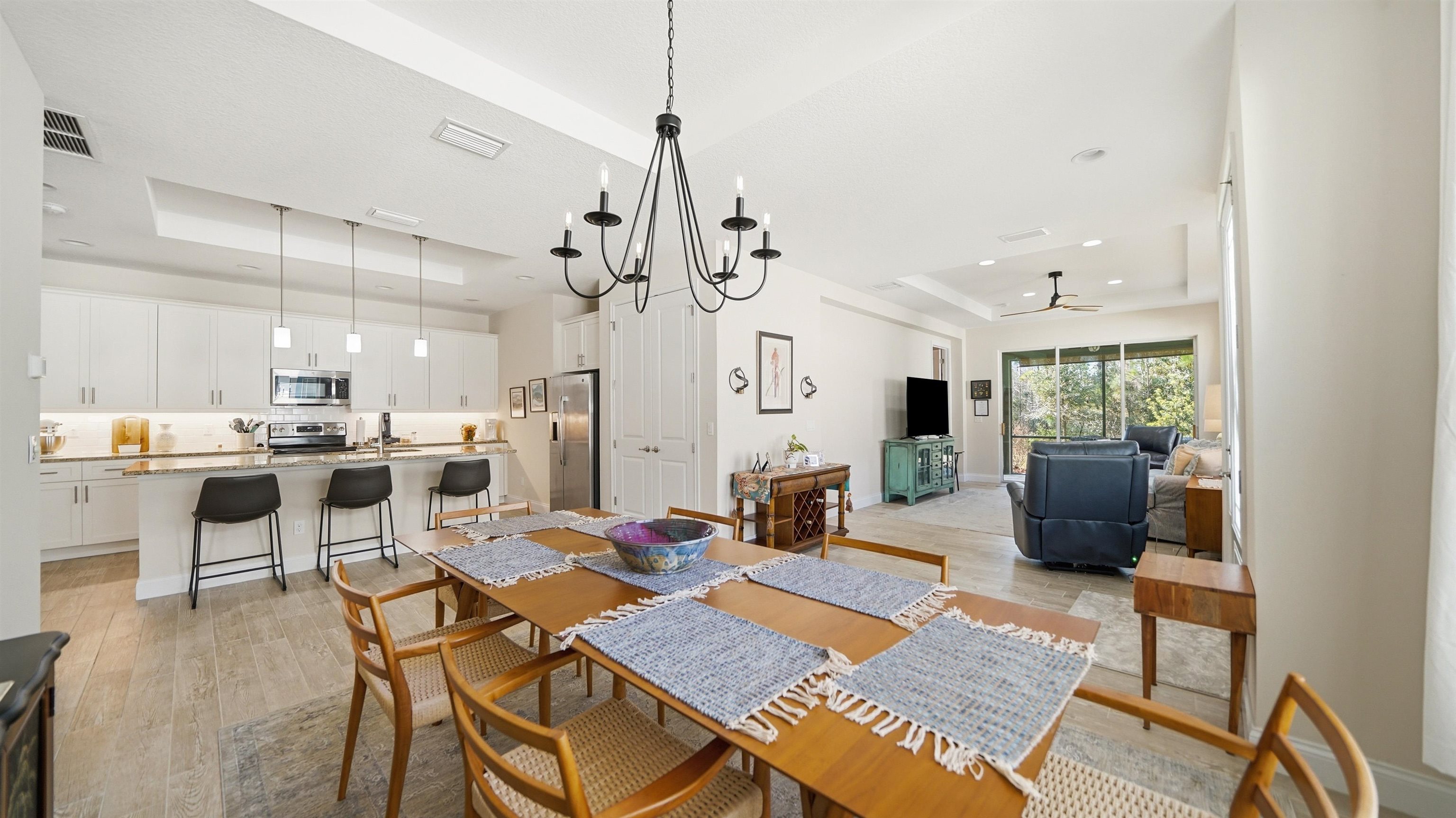 74 Wrendale Loop Ormond Beach, FL 32174 - Photo 13 of 59 Dining space with a raised ceiling, light wood finished floors, hanging lights, and a ceiling fan