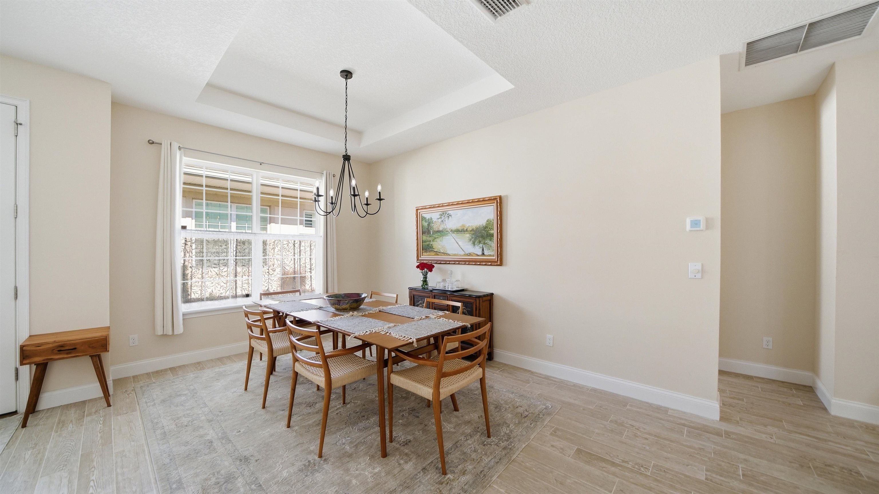 74 Wrendale Loop Ormond Beach, FL 32174 - Photo 14 of 59 a dining room with furniture a chandelier and wooden floor