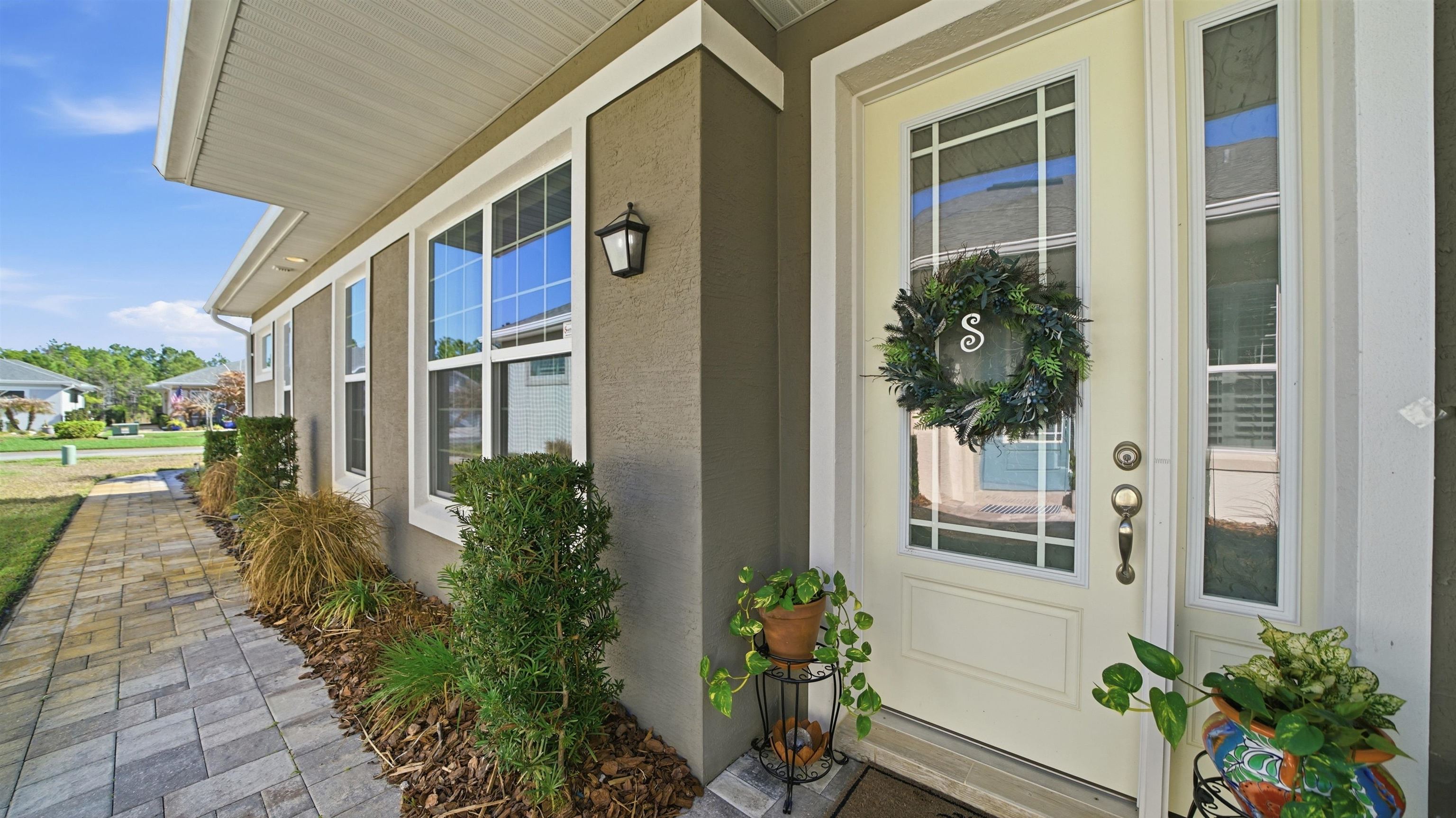 74 Wrendale Loop Ormond Beach, FL 32174 - Photo 3 of 59 Property entrance featuring covered porch and stucco siding