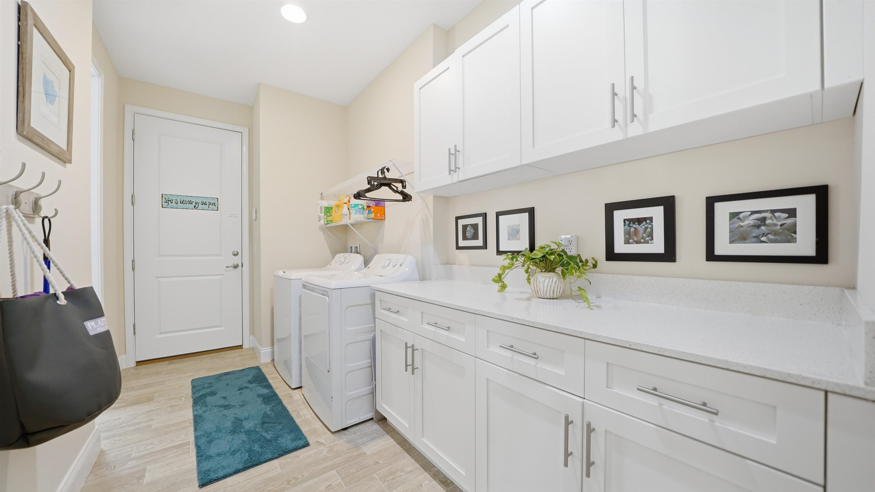 74 Wrendale Loop Ormond Beach, FL 32174 - Photo 31 of 59 Laundry room with light wood-type flooring, washing machine and clothes dryer, cabinet space, and recessed lighting