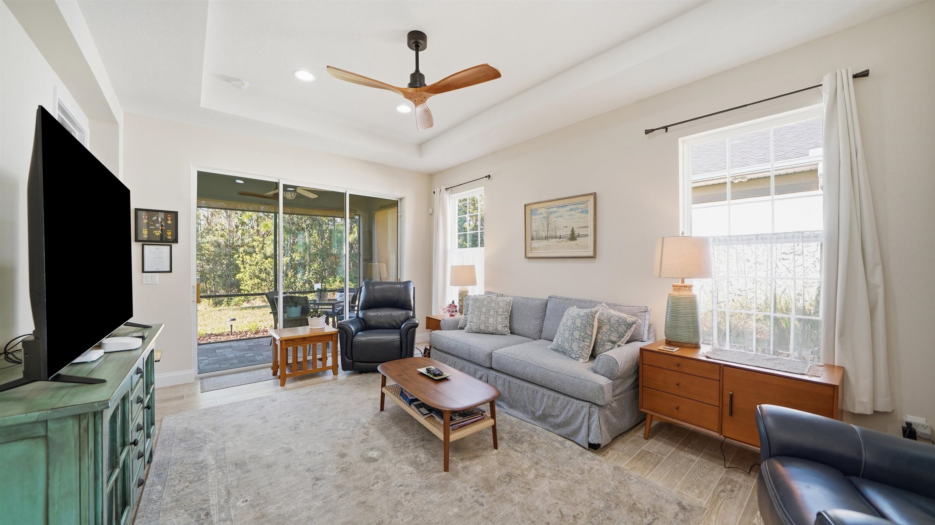 74 Wrendale Loop Ormond Beach, FL 32174 - Photo 4 of 59 a living room with furniture a flat screen tv and a large window
