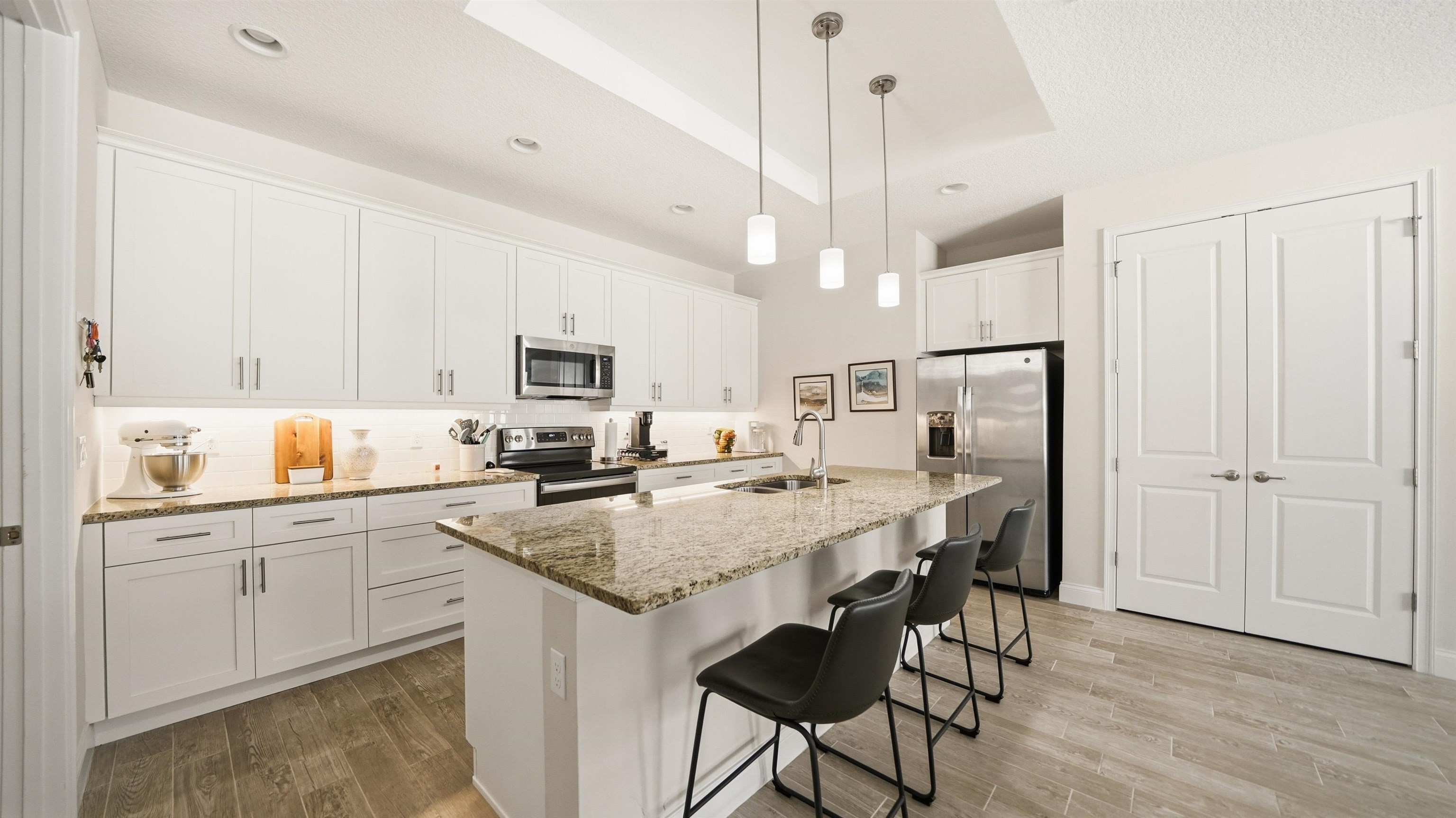 74 Wrendale Loop Ormond Beach, FL 32174 - Photo 8 of 59 a kitchen with stainless steel appliances a stove a sink a refrigerator a center island and a cabinets
