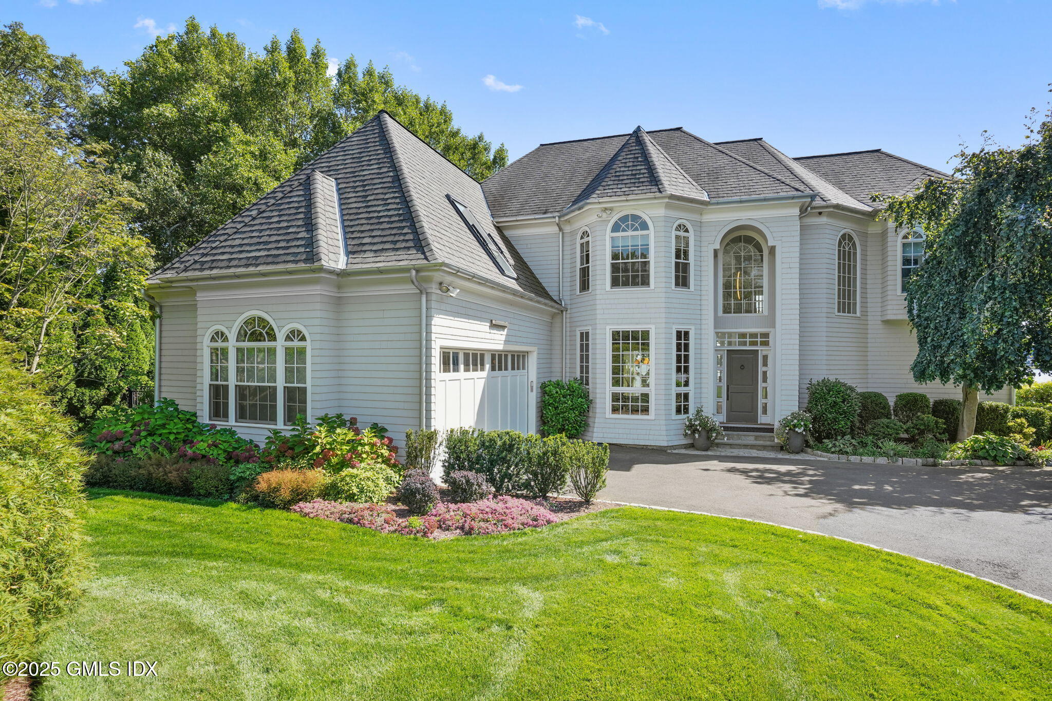 19 Weeds Landing Darien, CT 06820 - Photo 12 of 98 a front view of a house with a yard and potted plants
