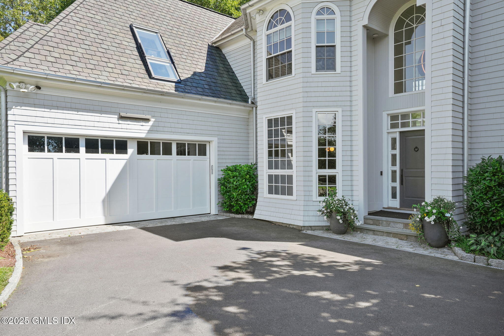 19 Weeds Landing Darien, CT 06820 - Photo 26 of 98 a front view of a house with a yard and potted plants