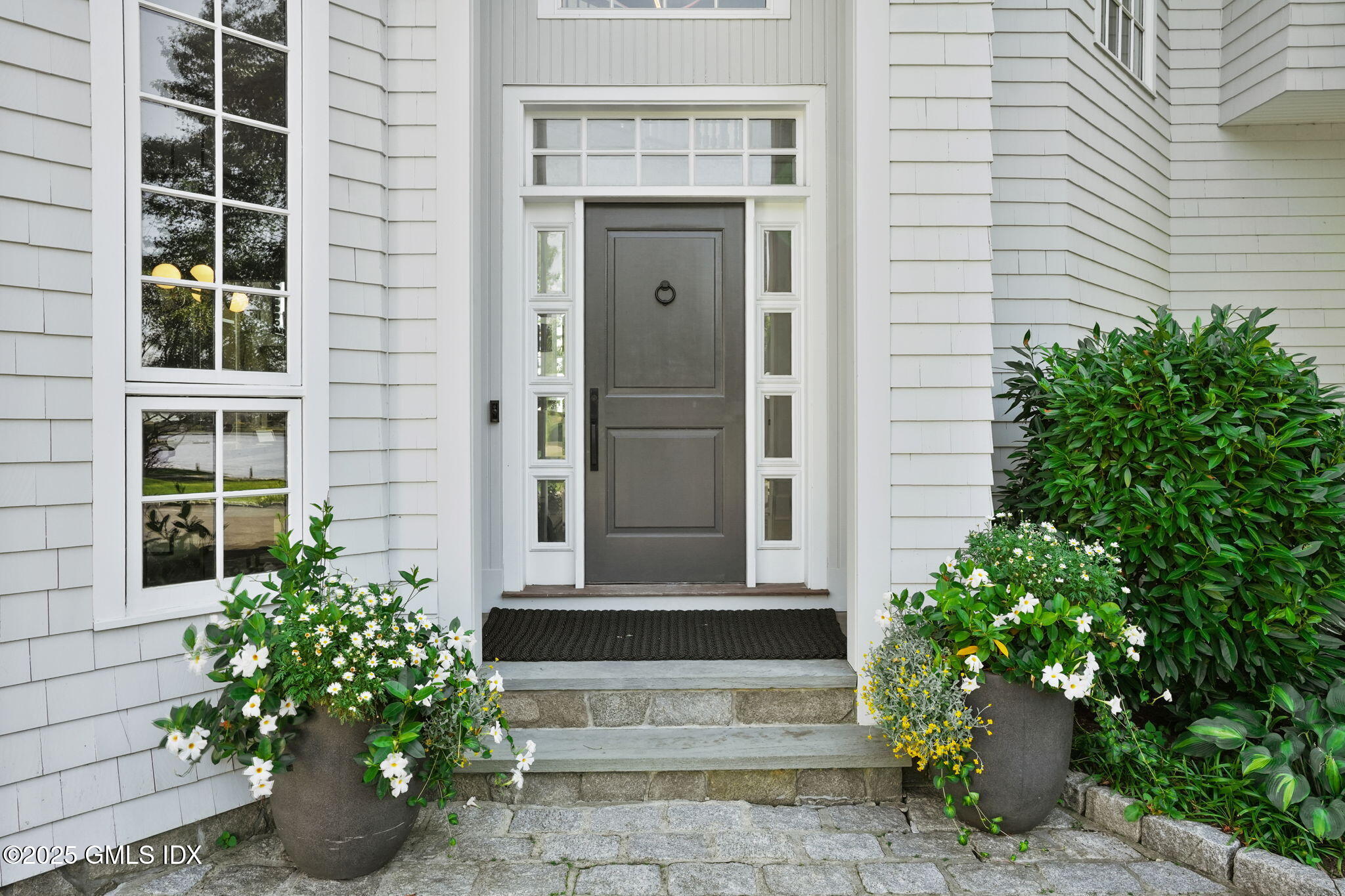 19 Weeds Landing Darien, CT 06820 - Photo 27 of 98 a front view of a house with a garden