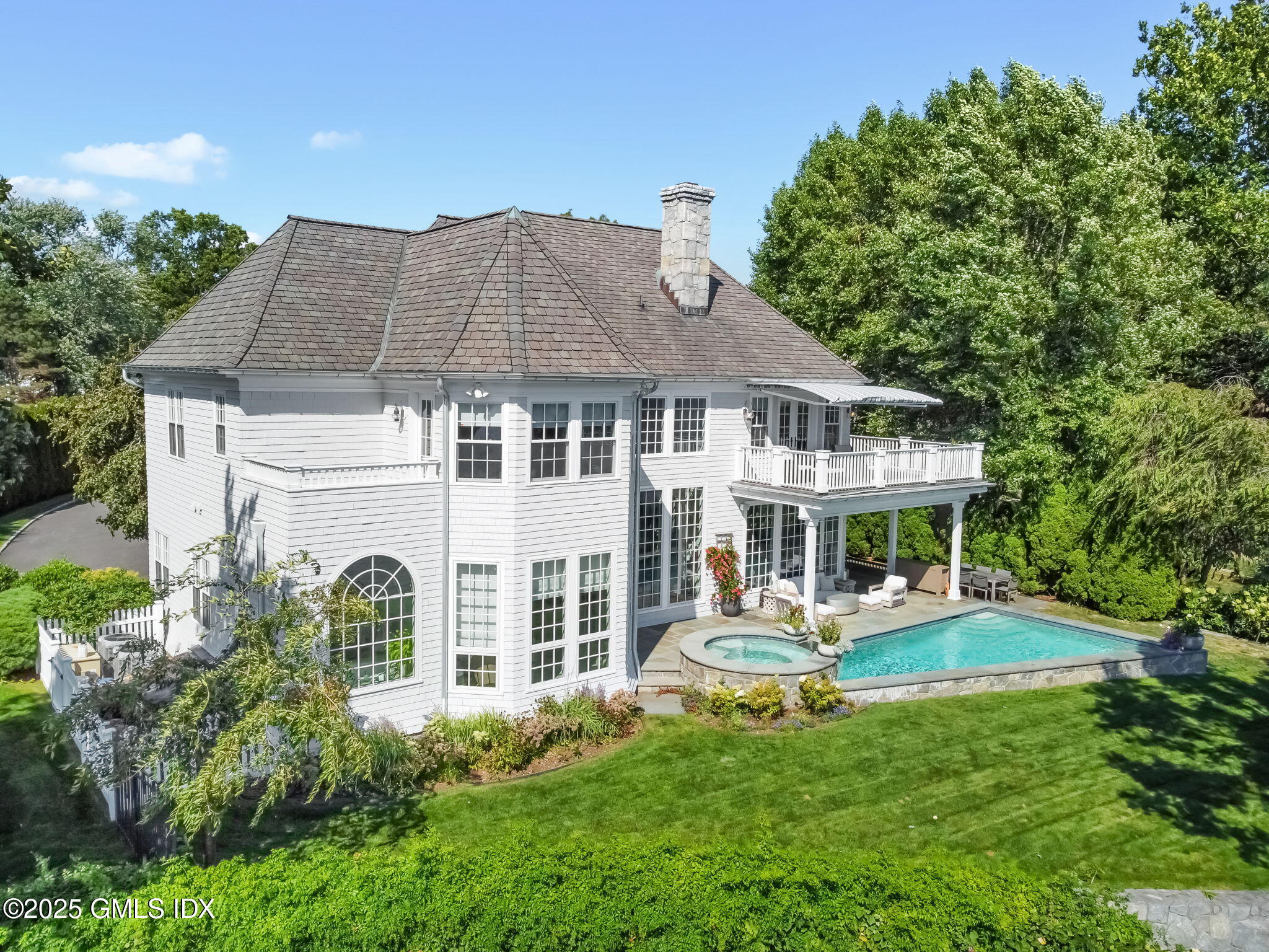 19 Weeds Landing Darien, CT 06820 - Photo 6 of 98 a front view of a house with a yard table and chairs