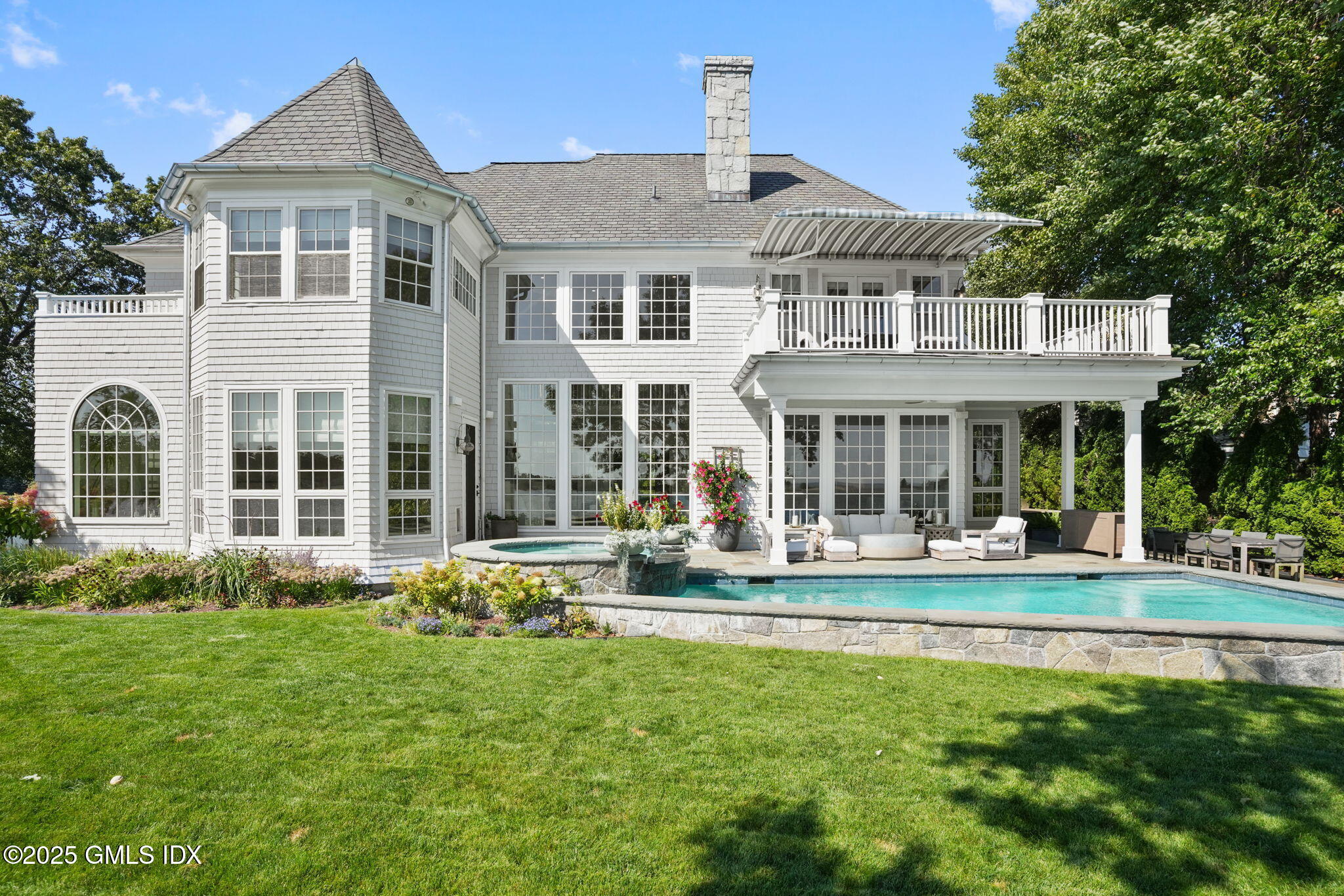 19 Weeds Landing Darien, CT 06820 - Photo 63 of 98 a front view of a house with a yard table and chairs