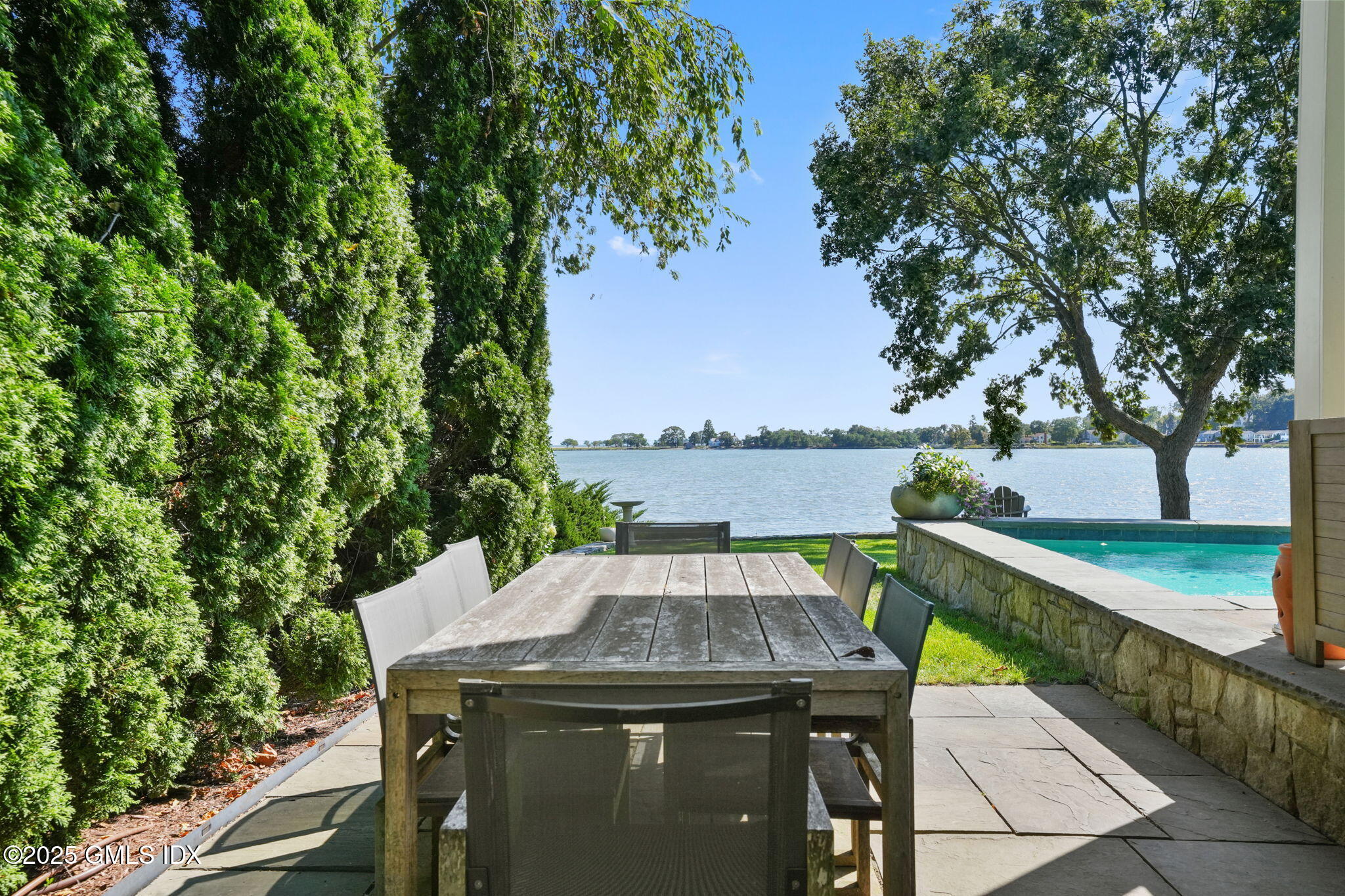 19 Weeds Landing Darien, CT 06820 - Photo 65 of 98 a view of a balcony with furniture and an umbrella