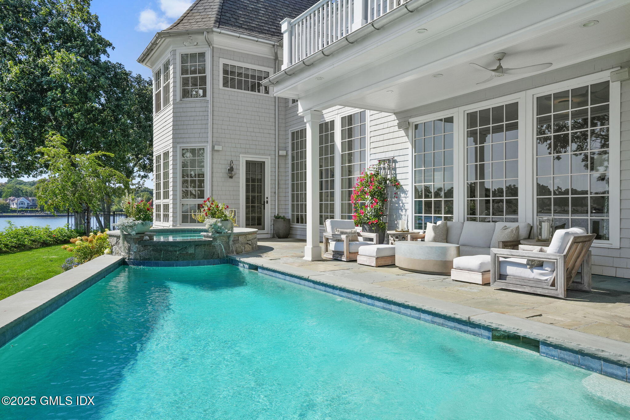 19 Weeds Landing Darien, CT 06820 - Photo 68 of 98 a view of swimming pool with outdoor seating and a garden