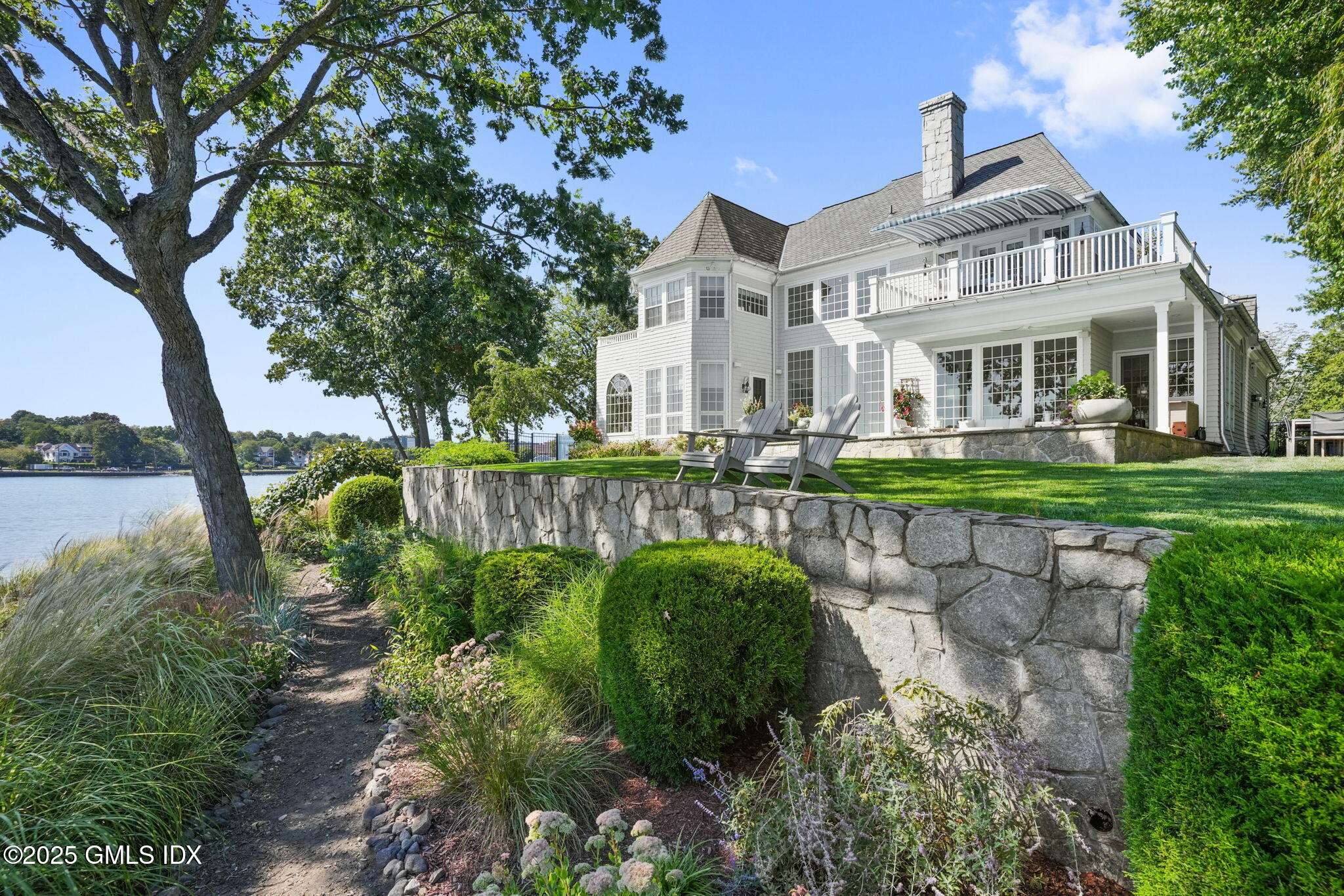 19 Weeds Landing Darien, CT 06820 - Photo 70 of 98 a front view of a house with a yard table and chairs