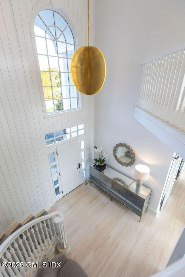 19 Weeds Landing Darien, CT 06820 - Photo 82 of 98 a bedroom with a bed and a chandelier