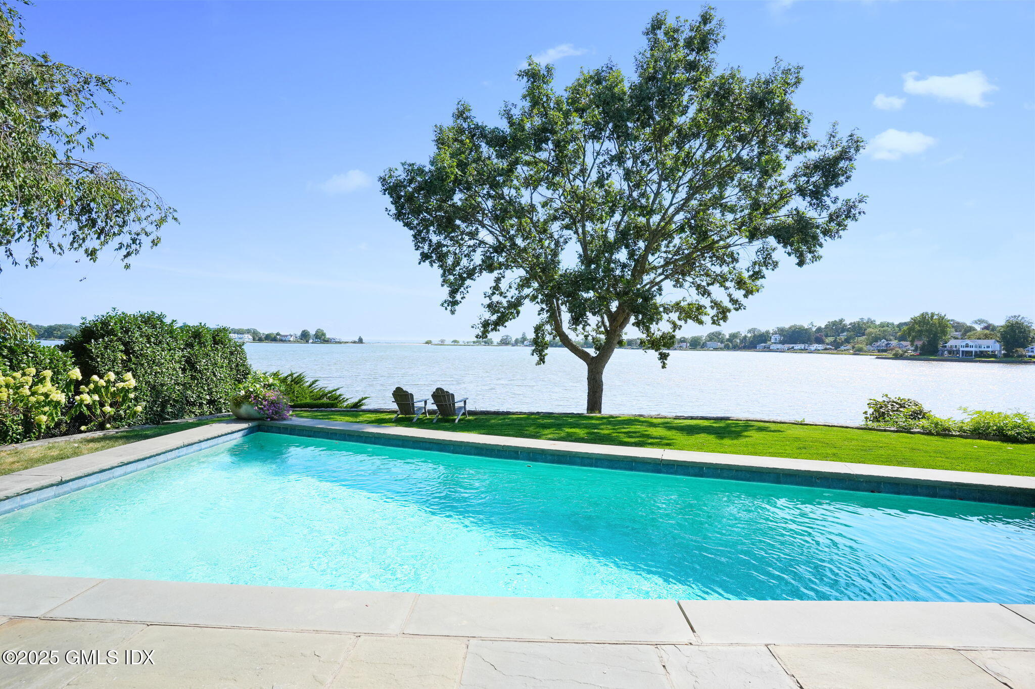19 Weeds Landing Darien, CT 06820 - Photo 9 of 98 a view of a swimming pool with an outdoor space and seating area