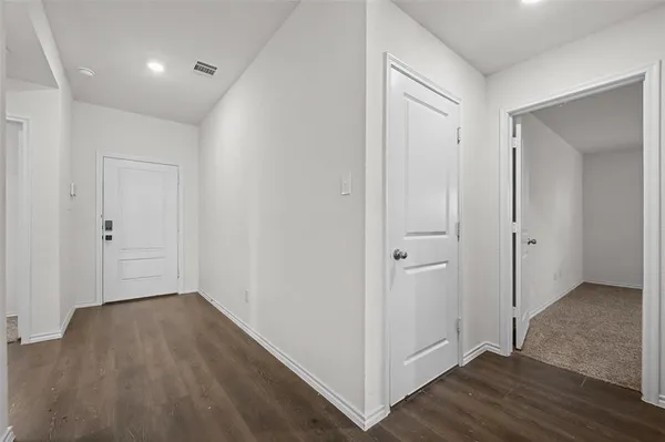 a view of hallway with wooden floor