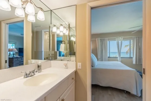 a bedroom with two beds and window