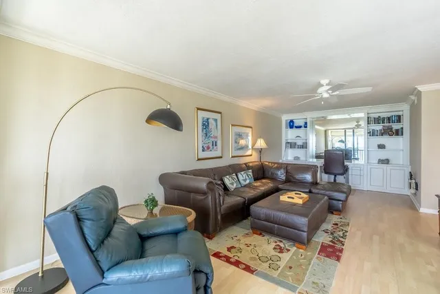 a view of a workspace with furniture and a book shelf