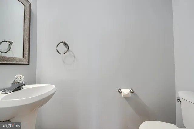 a bathroom with a sink mirror and toilet