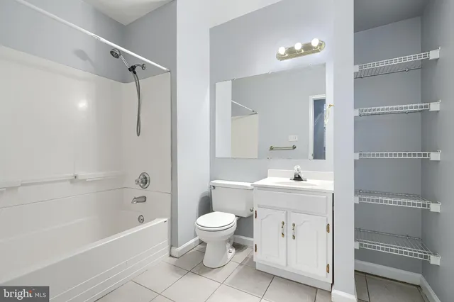 a bathroom with a sink a toilet and a large mirror