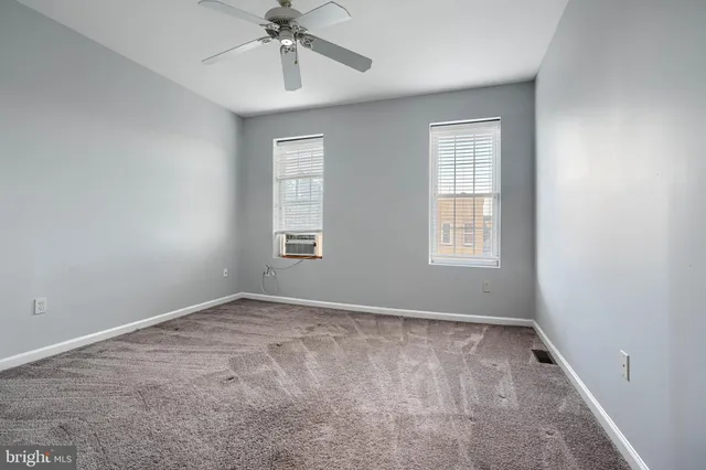 a view of an empty room and a window