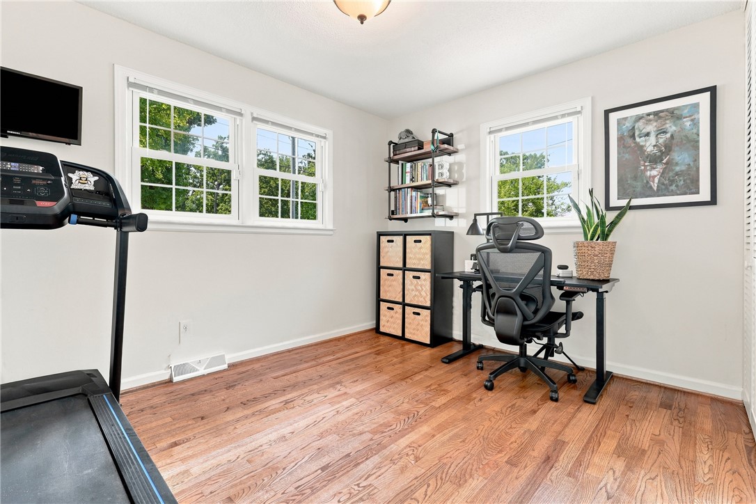 204 Sylvia Road Easley, SC 29642 - Photo 23 of 36 Natural light floods this versatile space, featuring rich hardwood flooring and pristine white trim.