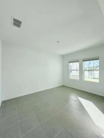 an empty room with a empty space and windows