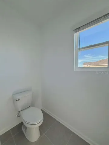 a view of an empty room and a window