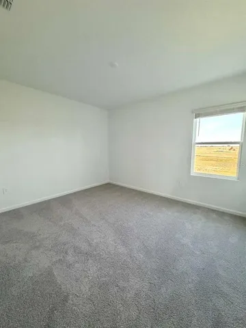 an empty room with an empty space and window