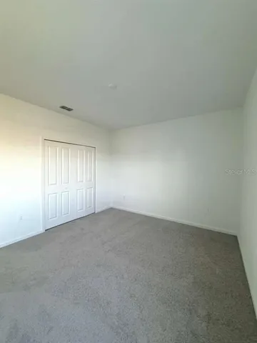 a view of an empty room and a window