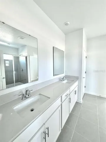 a view of a kitchen with white cabinets