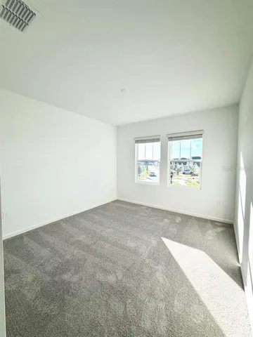 a spacious bathroom with a granite countertop sink a mirror and a bathtub