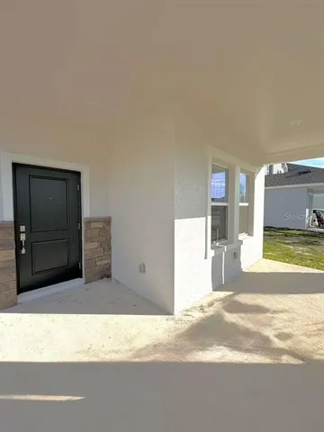 a view of a livingroom with a furniture and kitchen view