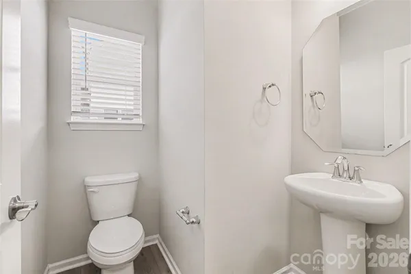 a bathroom with a toilet a sink and a window