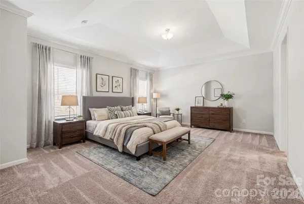 a spacious bedroom with a bed couch and window