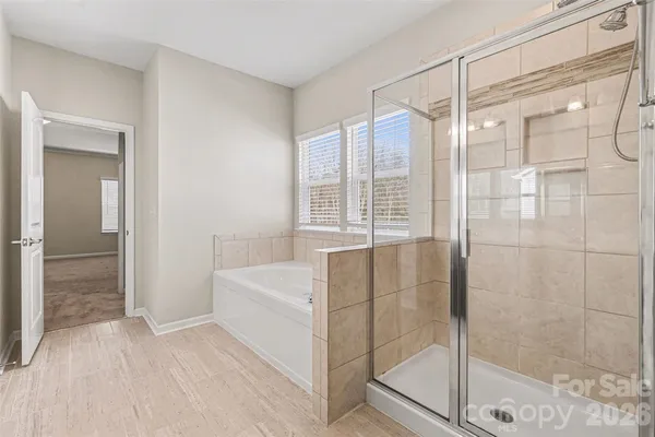 a bathroom with a shower and a glass door