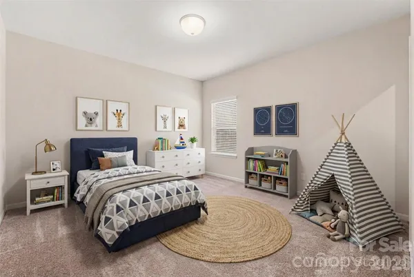 a bedroom with a large bed a fireplace and a large mirror