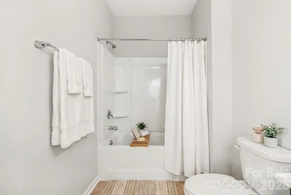 a bathroom with a shower curtain and a toilet