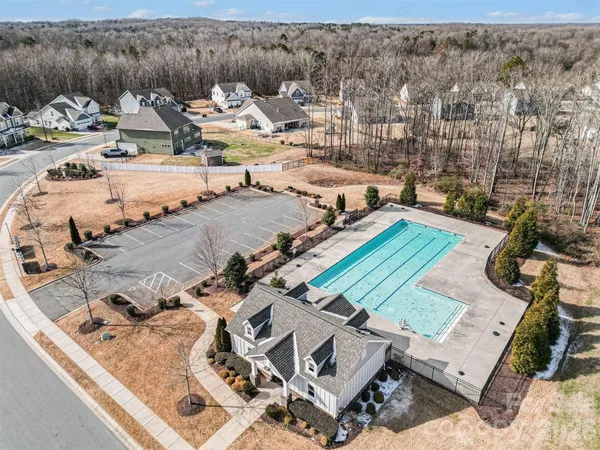 an aerial view of a houses with a yard