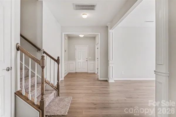 a view of an entryway with wooden floor