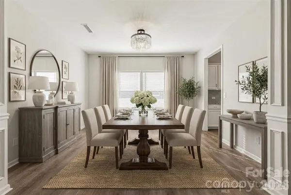 a view of a a dining room with furniture window and wooden floor