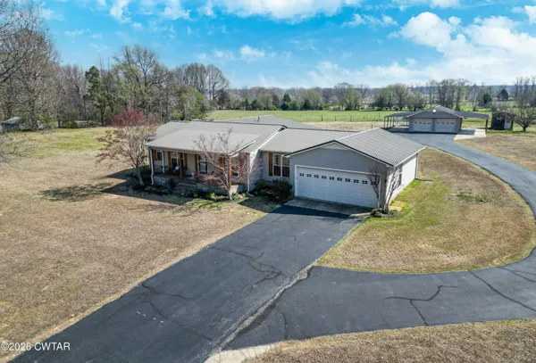 an aerial view of a house with garden space and outdoor seating