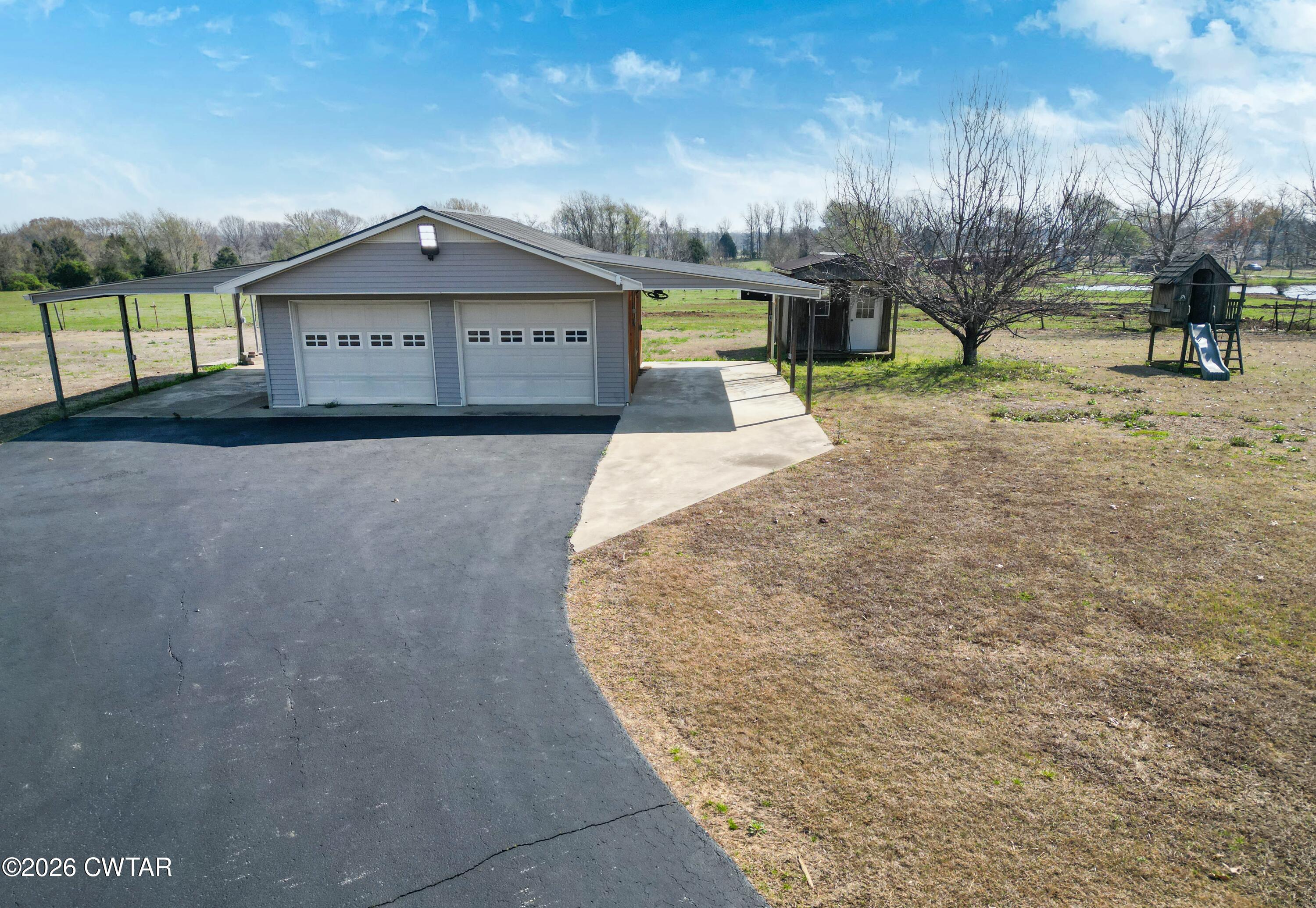 593 Sunny Hill Road Alamo, TN 38001 - Photo 11 of 29 a view of a house with a yard