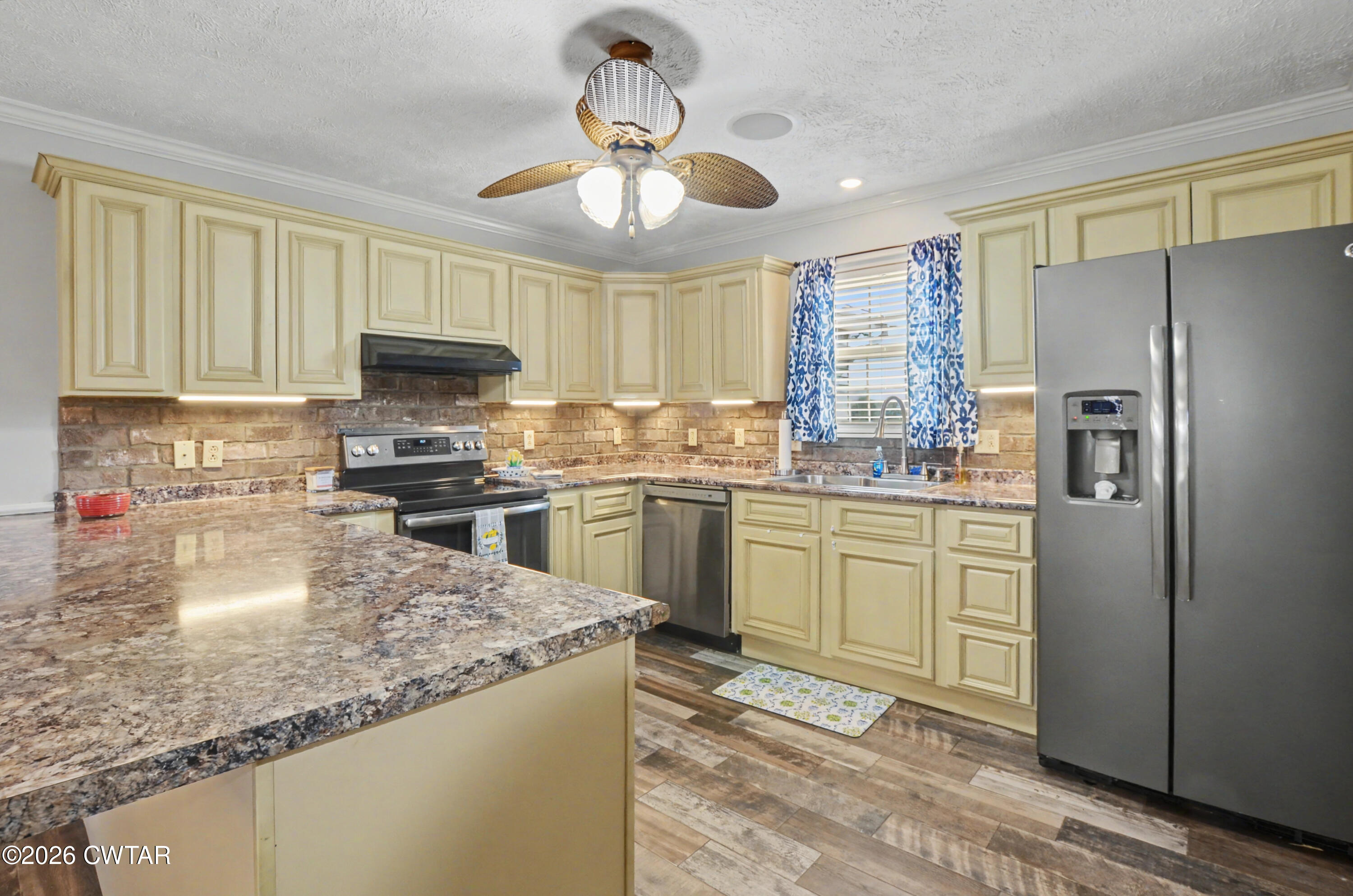 593 Sunny Hill Road Alamo, TN 38001 - Photo 17 of 29 a kitchen with a refrigerator a sink dishwasher with a dining table and chairs